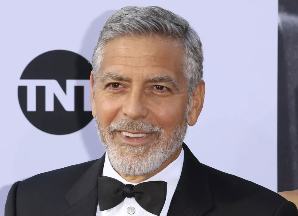 FILE - In this June 7, 2018, file photo, George Clooney arrives at the 46th AFI Life Achievement Award Honoring himself at the Dolby Theatre in Los Angeles. Clooney tops the 2018 Forbes' list of highest-paid actors with $239 million in pretax earnings. Forbes credits up to $1 billion that a British conglomerate said it would pay for Casamigos Tequila, which Clooney co-founded in 2013 with two entrepreneurs. (Photo by Willy Sanjuan/Invision/AP, File)