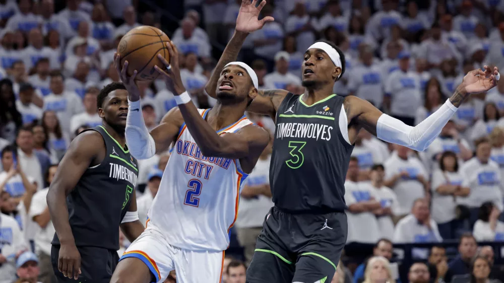 May 20, 2025; Oklahoma City, Oklahoma, USA; Oklahoma City Thunder guard Shai Gilgeous-Alexander (2) drives against Minnesota Timberwolves forward Jaden McDaniels (3) in the fourth quarter during game one of the western conference finals for the 2025 NBA Playoffs at Paycom Center. Mandatory Credit: Alonzo Adams-Imagn Images