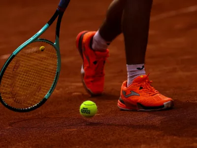 "Roland Garros 2025" tennis ball is seen during a practice session between Richard Gasquet and Mariano Navone ahead of the French Open tennis tournament in Paris, France May 20, 2025. REUTERS/Gonzalo Fuentes