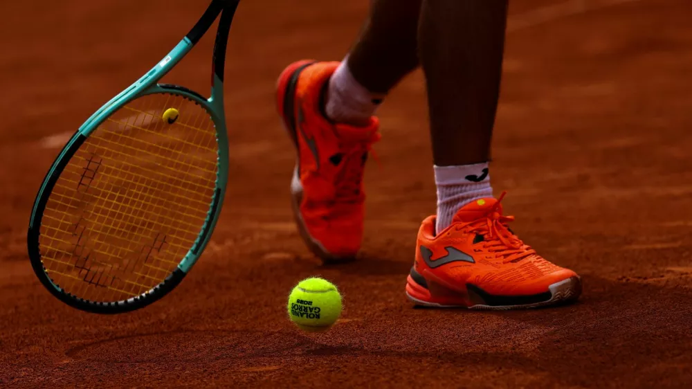 "Roland Garros 2025" tennis ball is seen during a practice session between Richard Gasquet and Mariano Navone ahead of the French Open tennis tournament in Paris, France May 20, 2025. REUTERS/Gonzalo Fuentes