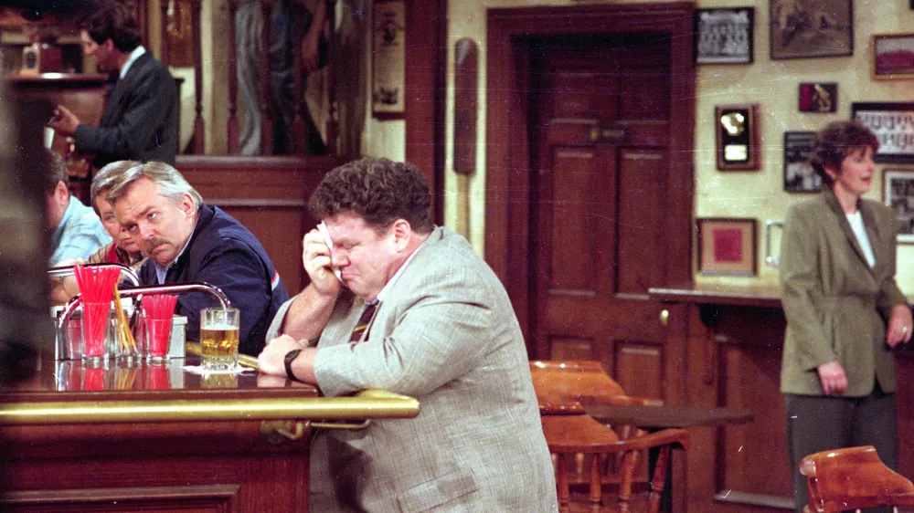 George Wendt, right, who portrays Norm Peterson sheds a tear on the set of the popular NBC series, "Cheers," as John Ratzenberger, portraying Cliff Calvin, looks away during a scene while taping the final episode in Los Angeles, Calif., on April 1, 1993. (AP Photo/Mark J. Terrill)