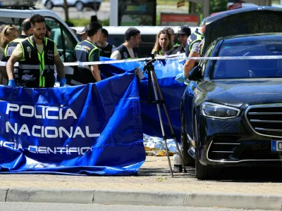 Members of the forensic team work at the spot where former Ukrainian politician Andriy Portnov, according to the Spain's Interior Ministry, was shot by unidentified gunmen, outside a school in a wealthy suburb of Madrid, in Madrid, Spain May 21, 2025. REUTERS/Nacho Doce
