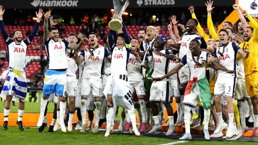 Tottenham Hotspur's Son Heung-Min lifts the trophy with teammates following the team's victory in the UEFA Europa League final against Manchester United at the Estadio de San Mames in Bilbao, Spain, Wednesday, May 21, 2025. (Nick Potts/PA via AP)
