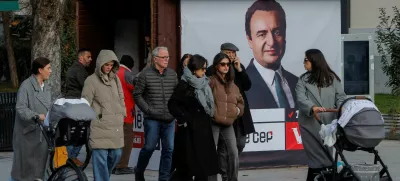 FILE PHOTO: Pedestrians walk near a campaign poster for the upcoming parliamentary elections showing a portrait of Albin Kurti, Kosovo's Prime Minister and leader of the Self-Determination party, in Pristina, Kosovo February 4, 2025. REUTERS/Valdrin Xhemaj/File Photo