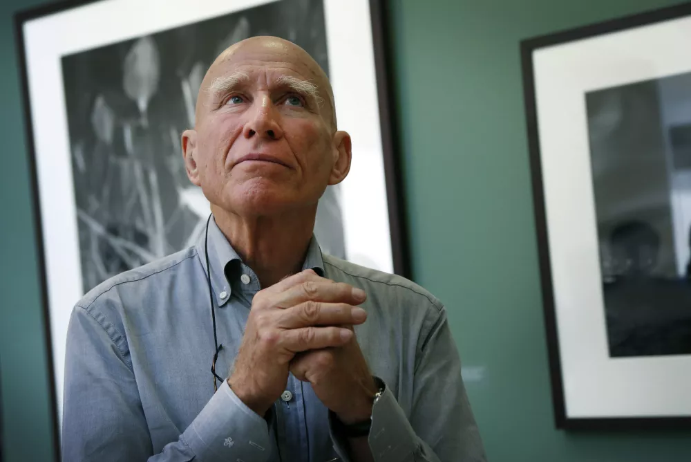 FILE - Brazilian photographer Sebasti&atilde;o Salgado leads a tour of his exhibition, "Sebasti&atilde;o Salgado: Genesis," on April 24, 2014, at the National Museum of Singapore. (AP Photo/Wong Maye-E, File)