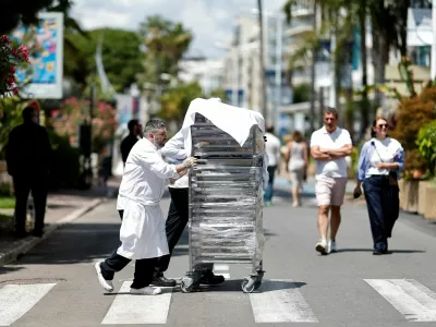Cooks bring out the food from the Carlton Hotel Beach Club on the Croisette following a major electricity outage, during the 78th Cannes Film Festival in Cannes, May 24, 2025. REUTERS/Benoit Tessier