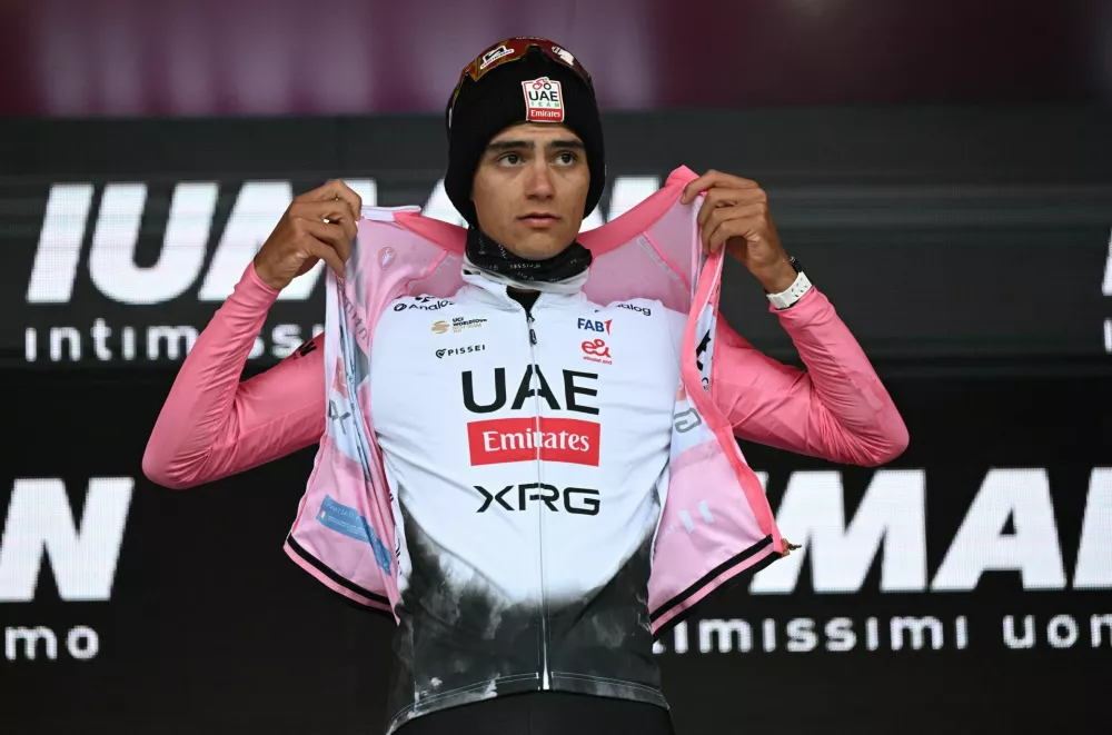 Cycling - Giro d'Italia - Stage 14 - Treviso to Nova Gorica - Slovenia - May 24, 2025 UAE Team Emirates's Isaac Del Toro puts on the maglia rosa jersey after stage 14 REUTERS/Jennifer Lorenzini