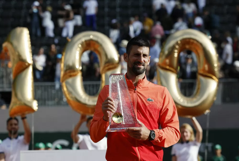 Tennis - Geneva Open - Tennis Club de Geneve, Geneva, Switzerland - May 24, 2025 Serbia's Novak Djokovic celebrates with the trophy after winning the final match against Poland's Hubert Hurkacz, Novak Djokovic's 100th career ATP tour title REUTERS/Stefan Wermuth
