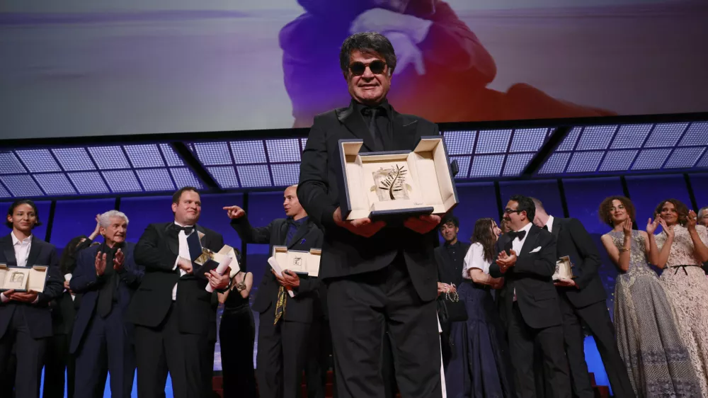 Director Jafar Panahi, accepts the Palme d'Or for the film 'It Was Just an Accident', during the awards ceremony of the 78th international film festival, Cannes, southern France, Saturday, May 24, 2025. (Photo by Joel C Ryan/Invision/AP)