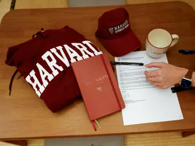 Yu-Hsuan Lin, 27, lays out a Harvard hat, mug, hoodie and her admission letter to Harvard University on a table in Taipei, Taiwan May 24, 2025. REUTERS/Ann Wang