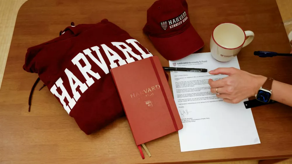 Yu-Hsuan Lin, 27, lays out a Harvard hat, mug, hoodie and her admission letter to Harvard University on a table in Taipei, Taiwan May 24, 2025. REUTERS/Ann Wang