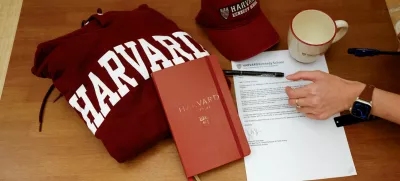Yu-Hsuan Lin, 27, lays out a Harvard hat, mug, hoodie and her admission letter to Harvard University on a table in Taipei, Taiwan May 24, 2025. REUTERS/Ann Wang