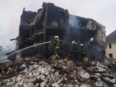 Rescue workers extinguish a fire of a house destroyed by a Russian strike in Markhalivka village, Kyiv region, Ukraine, Sunday, May 25, 2025. (AP Photo/Evgeniy Maloletka)