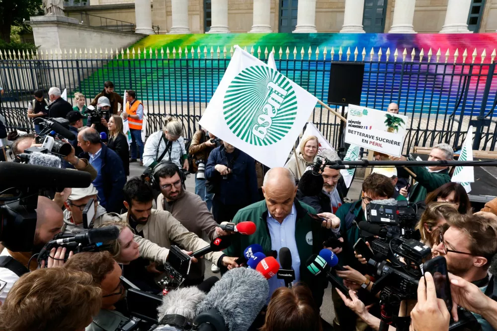 Arnaud Rousseau, president of Federation Nationale des Syndicats d'Exploitants Agricoles (FNSEA), speaks to the media in front of the French parliament, the Assemblee Nationale, as French farmers gather for a protest to call on lawmakers to adopt a bill that would loosen restrictions on pesticide and water use in farming, in Paris, France May 26, 2025. REUTERS/Abdul Saboor