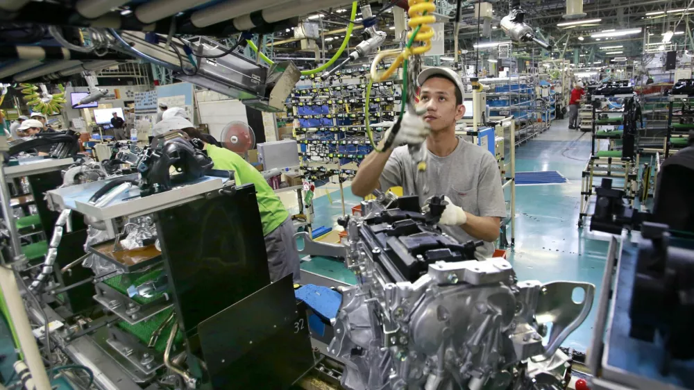 In this Aug. 2, 2017, photo, Nissan Motor Co. factory workers check engines on an assembly line at its plant in Yokohama, near Tokyo. Aiming to get an edge on its rivals in an intensely competitive industry, Japanese automaker Nissan says it&acirc;&euro;&trade;s attempting to foster a corporate culture that will produce manufacturing innovations in leaps and bounds instead of steady incremental improvement. Its discussion of that effort is partly a swipe at bigger competitor Toyota Motor Corp. which for decades has favored the concept of &acirc;&euro;śkaizen&acirc;&euro;ť or fine tuning and bit-by-bit progress in auto manufacturing. (AP Photo/Shizuo Kambayashi)