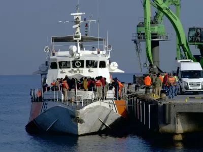 Migrants disembark after they were apprehended by the Turkish coast guard on the Aegean Sea between Turkey and Greece, in Dikili port, Turkey, Wednesday, April 6, 2016. The group of some 60 people were brought to a coast guard station in the western province of Izmir. The European Union began sending back migrants this week under a deal with Turkey aimed at preventing the flow of migrant to Europe.(AP Photo/Mehmet Guzel)