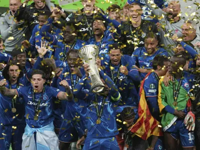 Chelsea's Reece James holds the trophy as he celebrates with his teammates after winning the Europa Conference League final soccer match between Real Betis and Chelsea in Wroclaw, Poland, Wednesday, May 28, 2025. (AP Photo/Darko Vojinovic)