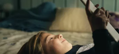 Sweet blondie girl playing on a Tablet PC.