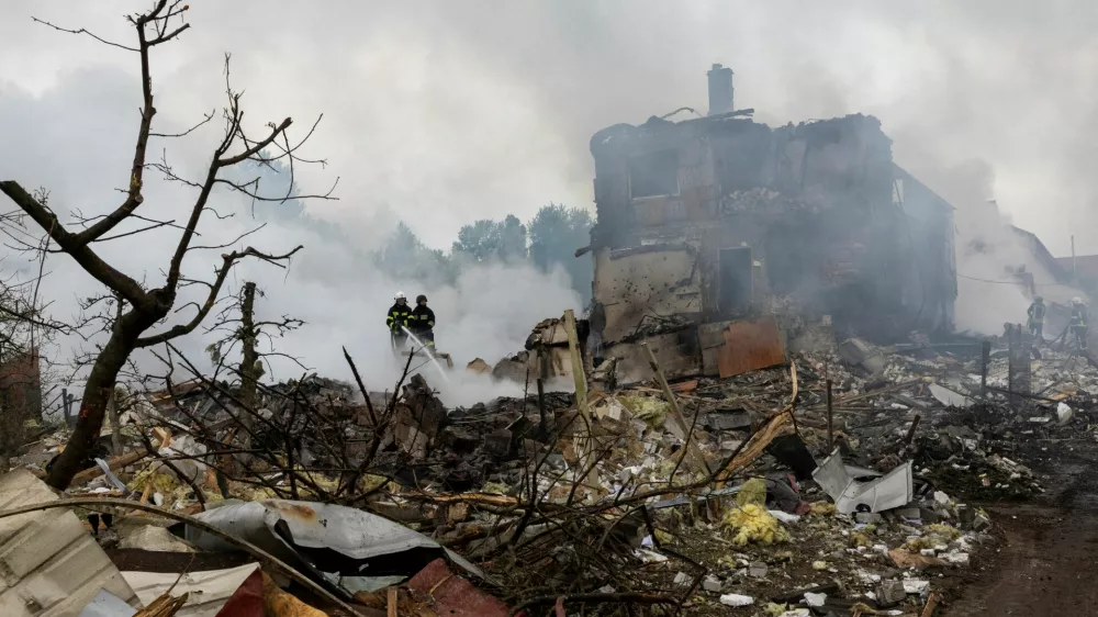 Emergency workers extinguish fire in the debris of a private house that was destroyed in a Russian rocket strike, amid Russia's attack on Ukraine, in Markhalivka, Kyiv region, Ukraine, May 25, 2025. REUTERS/Thomas Peter