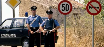 Italian carabinieri (military police) stand guard outside the small Sicilian town of Corleone in this 1992 file photo. Bernardo Provenzano, the undisputed chief of the Sicilian Mafia who had been on the run for more than four decades, was arrested while hiding in a farmhouse near Corleone in Sicily on April 11, 2006 officials said. Provenzano, known as the "Phantom of Corleone" after his native hill town, made famous by the Godfather films, has been running the Mafia since former "boss of bosses" Toto Riina was arrested in 1993. REUTERS/Tony Gentile