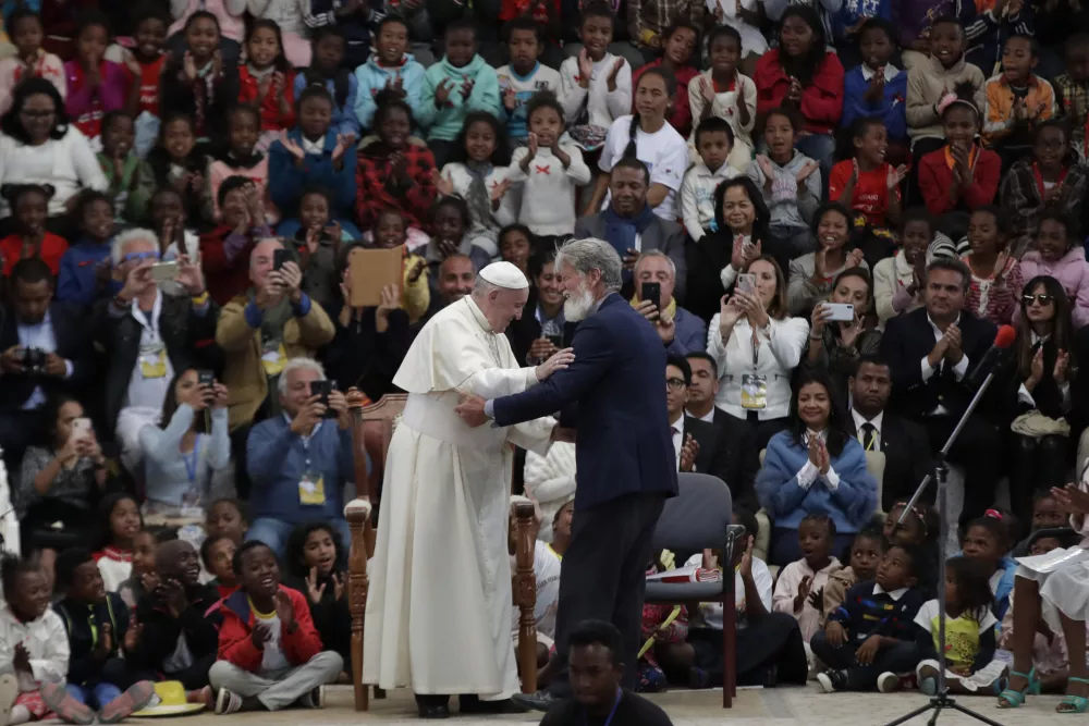 Pope Francis, left, is greeted by Father Pedro Opeka, founder the City of Friendship community, on the occasion of his visit in Akamasoa, Madagascar, Sunday, Sept. 8, 2019. Pope Francis is in Madagascar for the second leg of his weeklong trip to Africa. (AP Photo/Alessandra Tarantino)