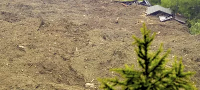 A large avalanche with a mixture of ice, rock, snow and water reach the valley floor is pictured in Wiler after the Birch glacier collapsing above Blatten, Switzerland, Wednesday, May 28, 2025. (Jean-Christophe Bott/Keystone via AP)