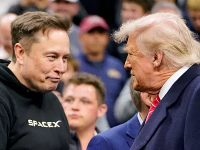 FILE PHOTO: Elon Musk greets U.S. President Donald Trump as they attend the NCAA men's wrestling championships in Philadelphia, Pennsylvania, U.S., March 22, 2025. REUTERS/Nathan Howard/File Photo