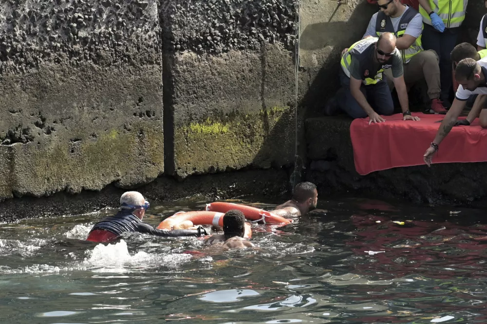 Survivors of a capsized boat are rescued in the port of El Hierro in the Canary Islands, Spain, on Wednesday, May 28, 2025. (Europa Press via AP) 