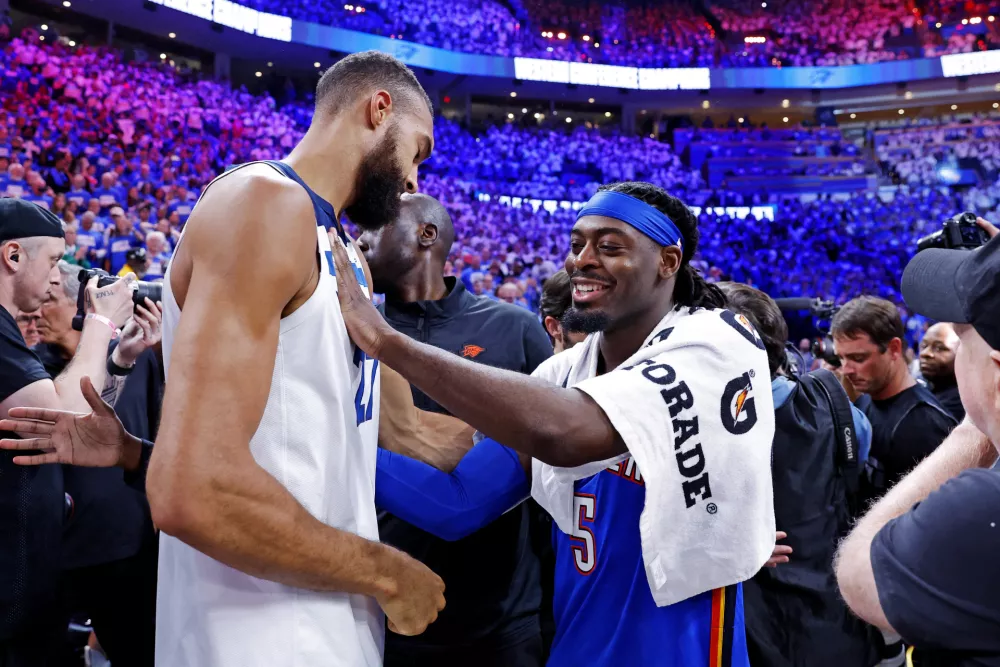 May 28, 2025; Oklahoma City, Oklahoma, USA; Oklahoma City Thunder guard Luguentz Dort (5) greets Minnesota Timberwolves center Rudy Gobert (27) after game five of the western conference finals for the 2025 NBA Playoffs at Paycom Center. Mandatory Credit: Alonzo Adams-Imagn Images