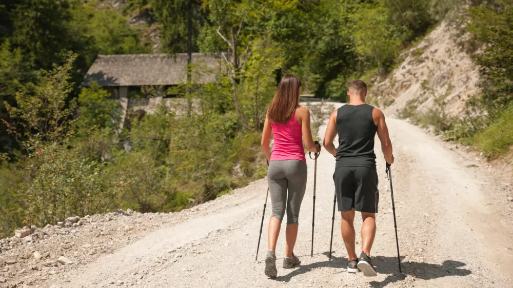 Active young couple on a hike in forest on a hot wummer day