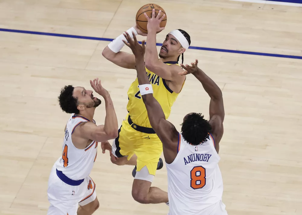 Indiana Pacers guard Andrew Nembhard (2) puts up a shot against New York Knicks forward OG Anunoby (8) and New York Knicks guard Landry Shamet (44) during the second quarter of Game 5 of the NBA basketball Eastern Conference final, Thursday, May 29, 2025, in New York. (AP Photo/Adam Hunger)