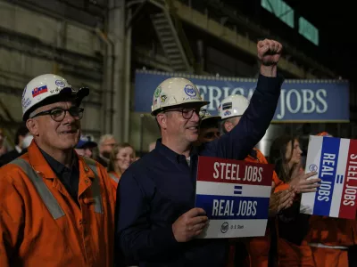 People listen as President Donald Trump speaks at U.S. Steel Corporation's Mon Valley Works-Irvin plant, Friday, May 30, 2025, in West Mifflin, Pa. (AP Photo/Julia Demaree Nikhinson)