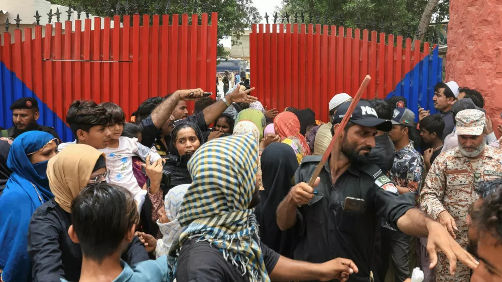 A police officer with a baton reacts as he disperses the family members of the prisoners, after dozens of prisoners escaped from the district Malir Jail, on the outskirts of Karachi, Pakistan, June 3, 2025. REUTERS/Akhtar Soomro