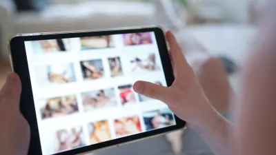 FILED - 14 April 2025, Hamburg: A young person looks at a porn website on a smartphone. Aylo, the company behind Pornhub, Redtube and Youporn, plans to block content from the afternoon onwards in protest at new French age verification regulations, local media reports said on Tuesday. Photo: Marcus Brandt/dpa
