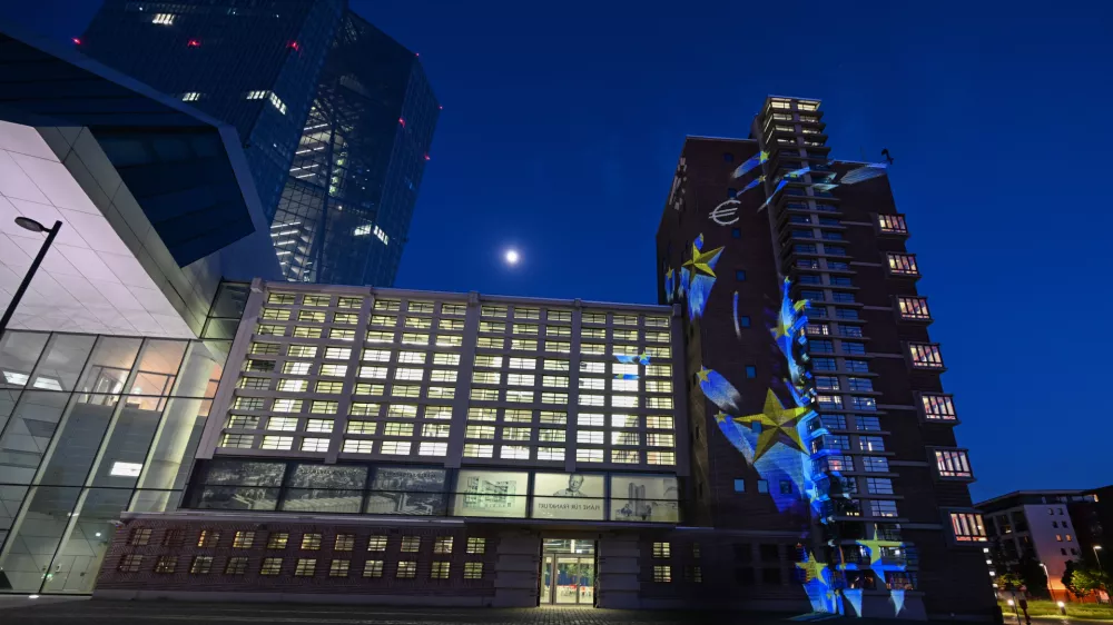 FILED - 08 May 2025, Hesse, Frankfurt/Main: Images of stars and euro signs are projected onto part of the former Frankfurt Grossmarkthalle at the European Central Bank (ECB). Photo: Arne Dedert/dpa