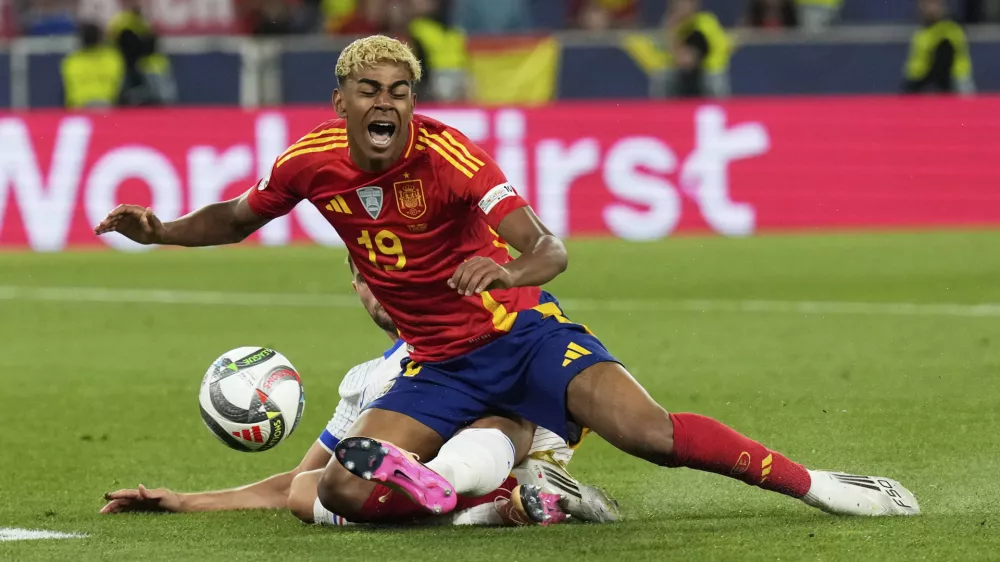 France's Adrien Rabiot fouls Spain's Lamine Yamal inside the penalty box during the Nations League semifinal soccer match between Spain and France in Stuttgart, Germany, Thursday, June 5, 2025. (AP Photo/Matthias Schrader)