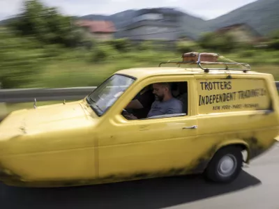 Tarik Fatic along with his brother Mirnes drives the Reliant Regal, an exact copy of the famous BBC TV show &nbsp;"Only Fools and Horses" iconic yellow car in Sarajevo, Bosnia, Wednesday, June 4, 2025. (AP Photo/Armin Durgut)