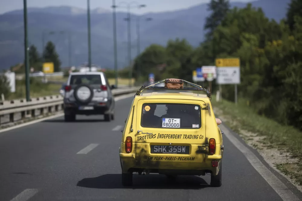 Tarik Fatic along with his brother Mirnes drives the Reliant Regal, an exact copy of the famous BBC TV show &nbsp;"Only Fools and Horses" iconic yellow car in Sarajevo, Bosnia, Wednesday, June 4, 2025. (AP Photo/Armin Durgut)
