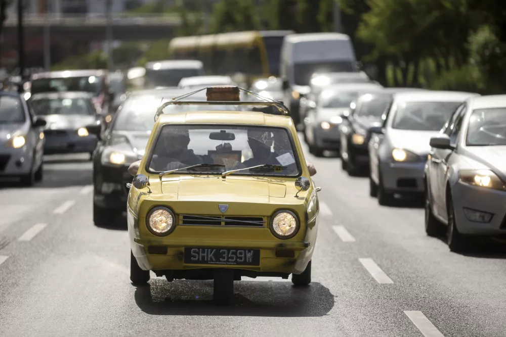Tarik Fatic along with his brother Mirnes drives the Reliant Regal, an exact copy of the famous BBC TV show &nbsp;"Only Fools and Horses" iconic yellow car in Sarajevo, Bosnia, Wednesday, June 4, 2025. (AP Photo/Armin Durgut)