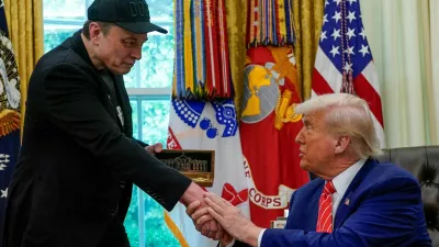 FILE PHOTO: Elon Musk receives a golden key from U.S. President Donald Trump in the Oval Office at the White House in Washington, D.C., U.S., May 30, 2025. REUTERS/Nathan Howard/File Photo
