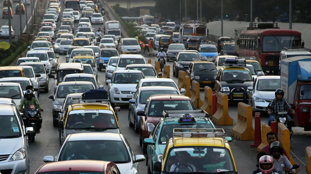 Traffic clogs a road in Mumbai, India, Friday, Dec. 5, 2014. India says it is taking bold steps against climate change with plans for a five-fold increase in renewable energy capacity. However, Environment Minister Prakash Javadekar said the country won't act to curb carbon emissions because it first must pursue economic growth to eradicate poverty. (AP Photo/Rajanish Kakade)
