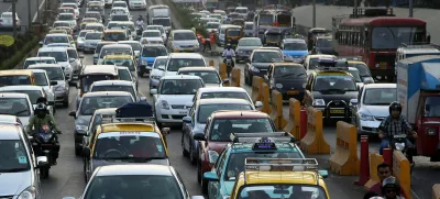 Traffic clogs a road in Mumbai, India, Friday, Dec. 5, 2014. India says it is taking bold steps against climate change with plans for a five-fold increase in renewable energy capacity. However, Environment Minister Prakash Javadekar said the country won't act to curb carbon emissions because it first must pursue economic growth to eradicate poverty. (AP Photo/Rajanish Kakade)