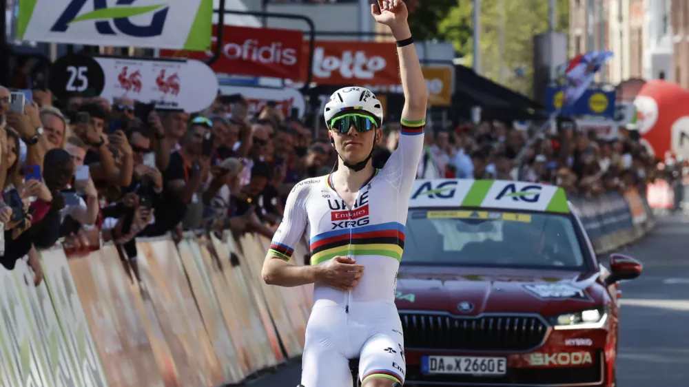 Slovenia's Tadej Pogacar of the UAE Team Emirates URG team crosses the finish line to win the Belgian cycling classic and UCI World Tour race Liege Bastogne Liege, in Liege, Belgium, Sunday, April 27, 2025. (AP Photo/Geert Vanden Wijngaert)