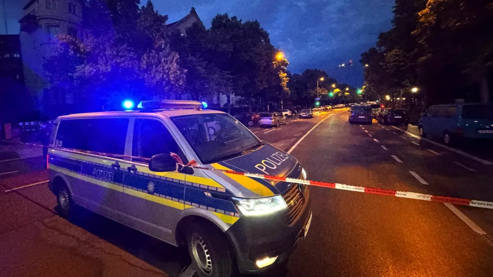 A police car secures the area where police responded with firearms to a woman who injured several passers-by with a knife, in Munich, Germany, June 7, 2025. REUTERS/Christine Uyanik