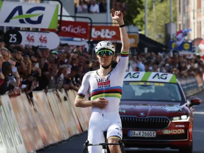 Slovenia's Tadej Pogacar of the UAE Team Emirates URG team crosses the finish line to win the Belgian cycling classic and UCI World Tour race Liege Bastogne Liege, in Liege, Belgium, Sunday, April 27, 2025. (AP Photo/Geert Vanden Wijngaert)