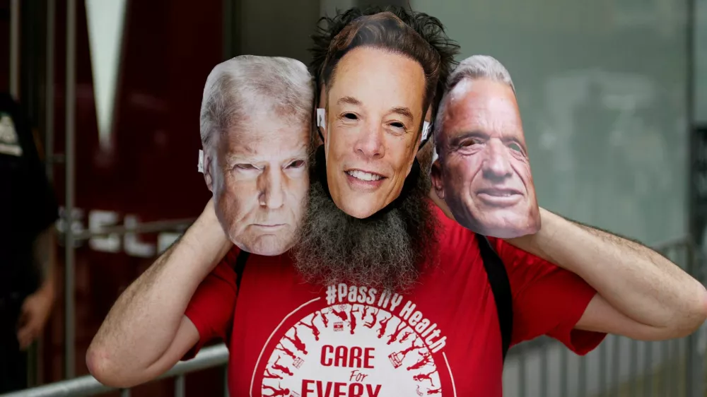 A person takes part in a protest against Tesla and its CEO Elon Musk outside a Tesla store in New York City, U.S. June 7, 2025. REUTERS/Eduardo Munoz