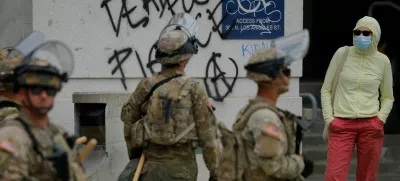 Members of the California National Guard stand outside the Edward R. Roybal federal building after their deployment by U.S. President Donald Trump, in response to protests against immigration sweeps, in Los Angeles, California, U.S. June 8, 2025. REUTERS/Mike Blake