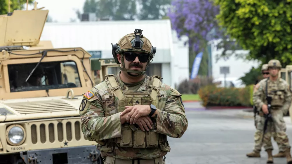 Members of the California National Guard stand guard at the Paramount Business Center parking lot a day after clashes between protesters and law enforcement following multiple detentions by Immigration and Customs Enforcement (ICE), in the Los Angeles County city of Paramount, California, U.S., June 8, 2025.  REUTERS/Jill Connelly