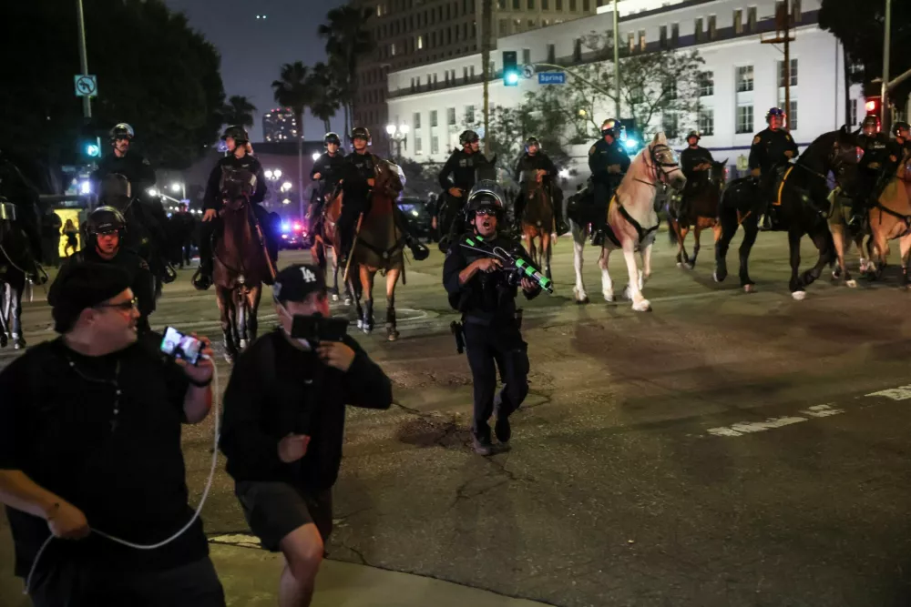 Members of law enforcement work to clear the area, as protests against federal immigration sweeps continue, in downtown Los Angeles, California, U.S. June 10, 2025. REUTERS/Leah Millis