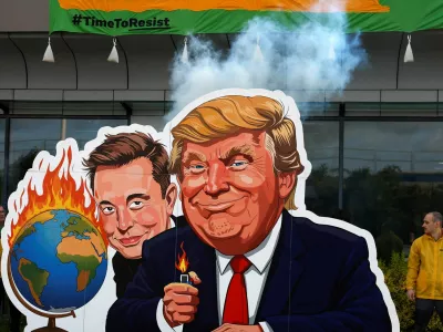 Greenpeace activists protest against the U.S. President Donald Trump and Tesla CEO Elon Musk as a part of a campaign "Time to Resist", which, according to them, is responding to the way billionaires are attacking the environment and society, in front of the Tesla dealership in Prague, Czech Republic, June 11, 2025. REUTERS/David W Cerny